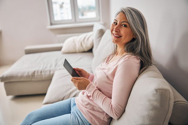 Charming elegant female with technology device