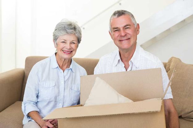 Cheerful senior couple moving into new home