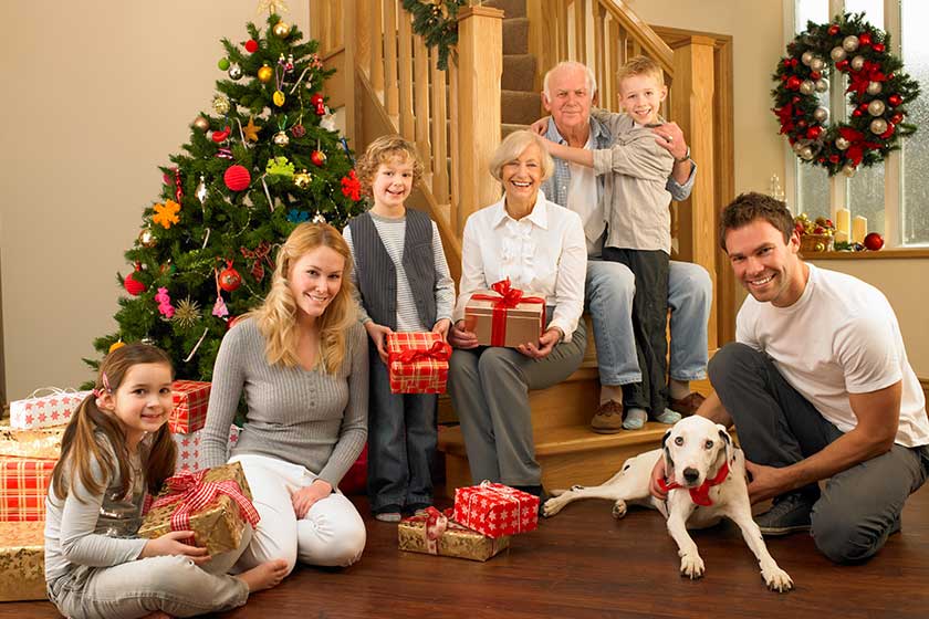 Family with gifts in front of Christmas tree Family with gifts in front of Christmas tree
