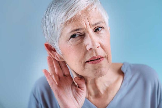 Hearing loss. Senior woman with symptoms of hearing