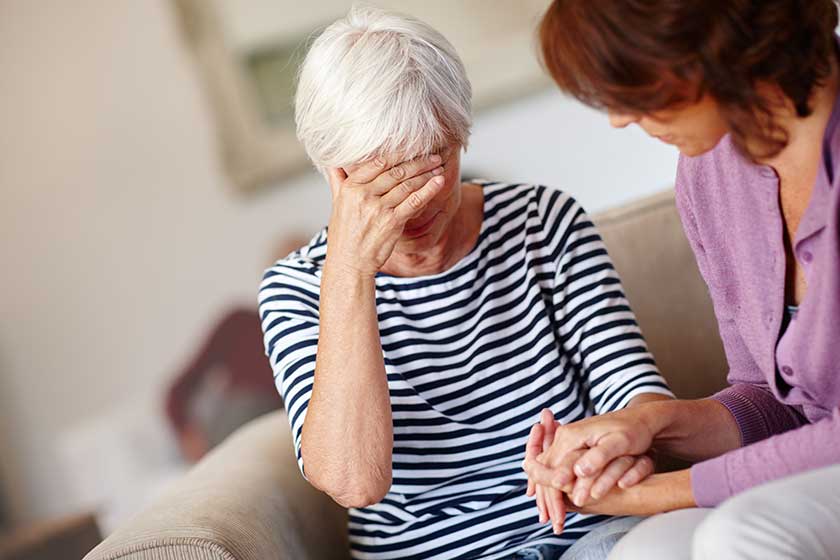 a woman comforting her elderly mother