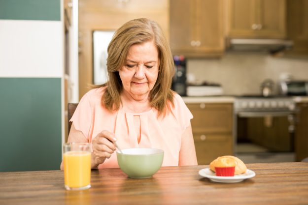 Senior adult woman forced to eat Senior