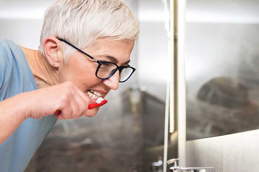 Man Helping Senior Mother Heart Attack Fallen Carpet