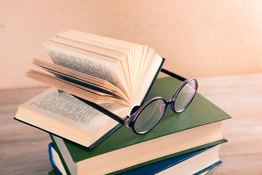 Pile of books and eyeglasses