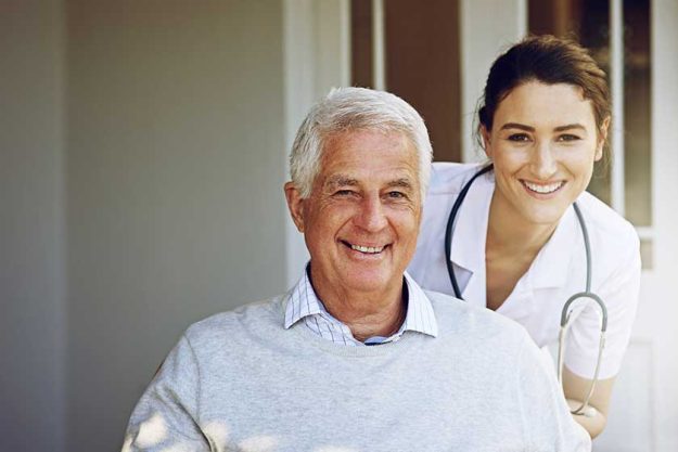 Portrait, smile and old man in wheelchair with caregiver