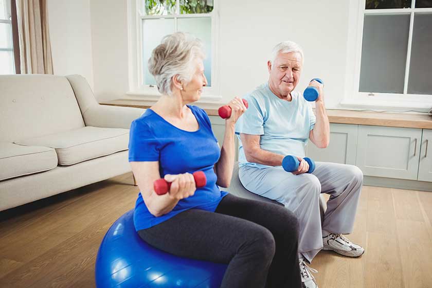 Senior couple lifting dumbbells