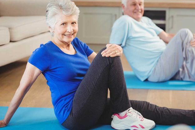 Senior couple performing yoga exercise