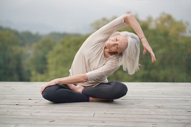 Serene senior woman meditating outdoors