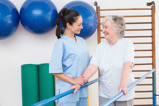 Senior woman walking with parallel bars Senior woman walking with parallel bars