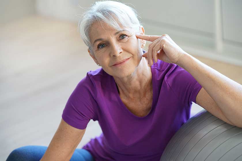 Woman sitting by fitness ball