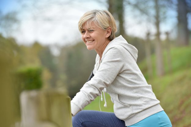 Senior woman stretching after exercising in natural landscape Debunking X Myths About Exercising In Your Senior Years When Aging At Alsuma, OK Senior Independent Facility