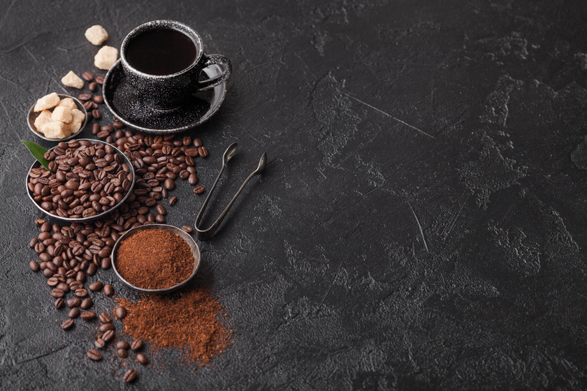 Cup of fresh raw organic coffee with beans and ground powder with cane sugar cubes with coffee tree leaf on black background. Top view Enjoying Active Senior Years In Tulsa, OK Independent Home Care: A Guide To The City's Coffee Scene