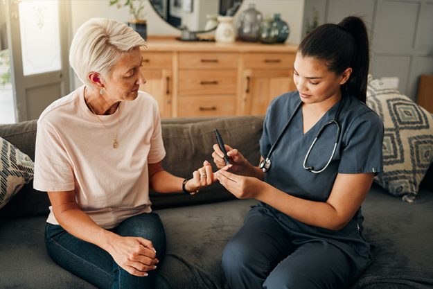 nurse and elderly woman finger doing blood test