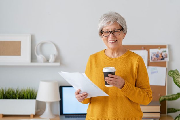 Happy casual senior woman working in home