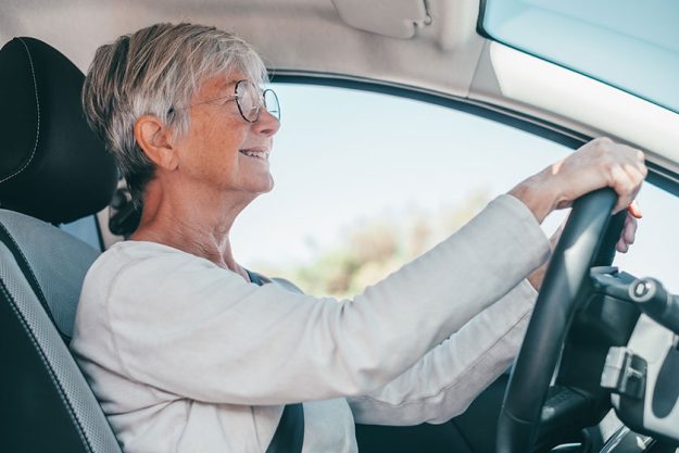 Handsome mature woman sitting relaxed in his newly bought car Handsome mature woman sitting relaxed in his newly bought car