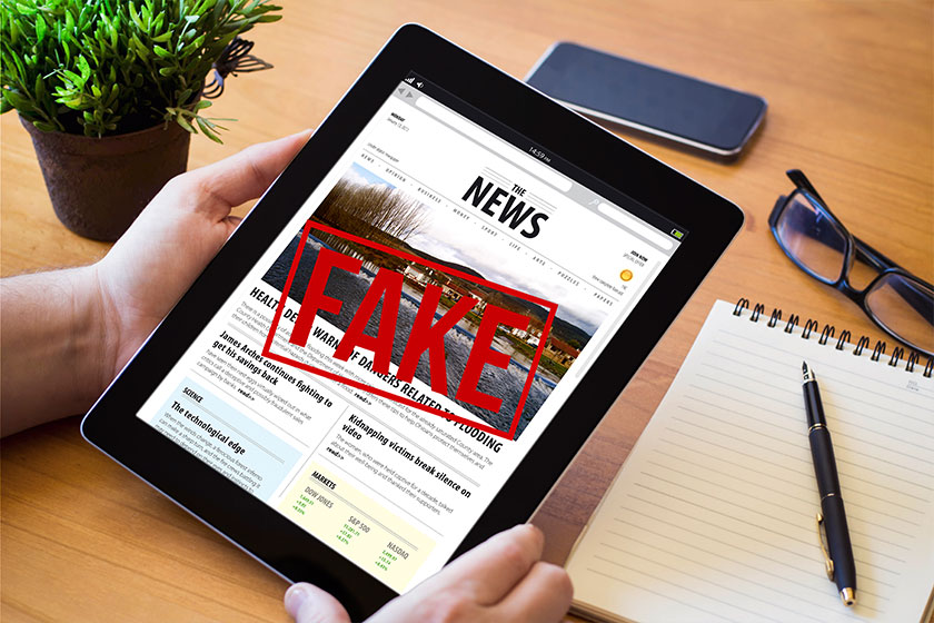 Man holding a fake news device