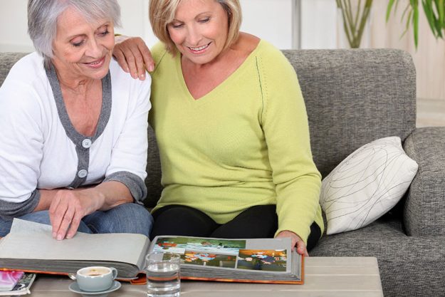 Mature women skimming through family album