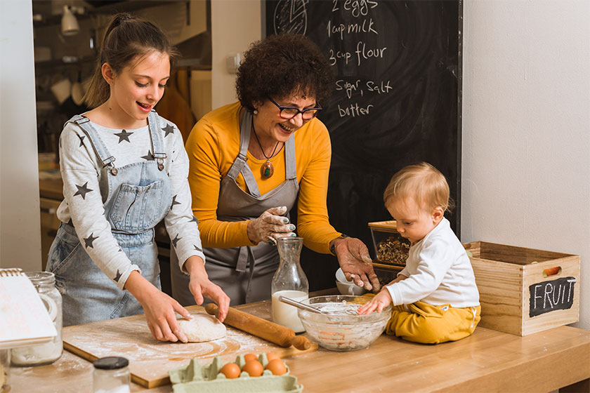 Senior woman with her grandchildren baking together in kitchen