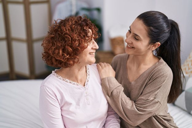 Two women mother and daughter hugging each other