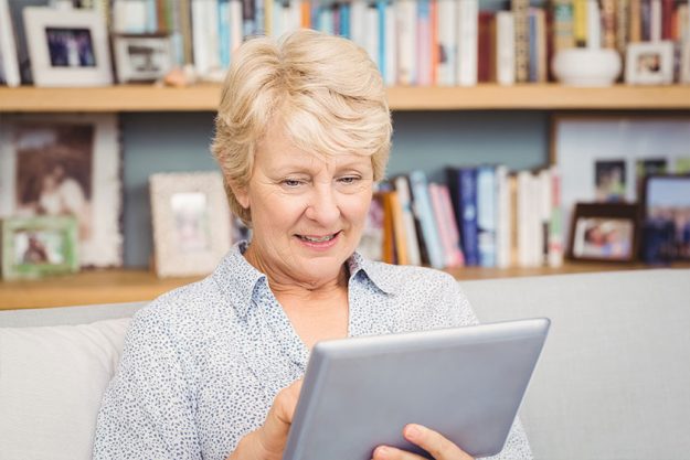 Woman using digital tablet at home Woman using digital tablet at home