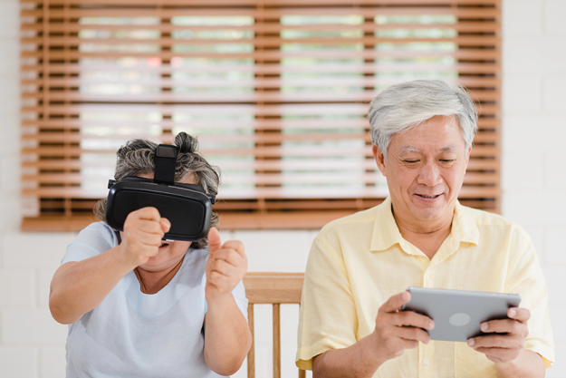 asian elderly couple using tablet and virtual reality simulator asian elderly couple using tablet and virtual reality simulator