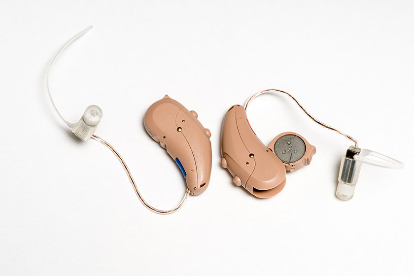 Close up of a pair of tiny modern hearing aids