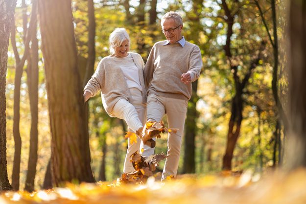 Happy senior couple in autumn park