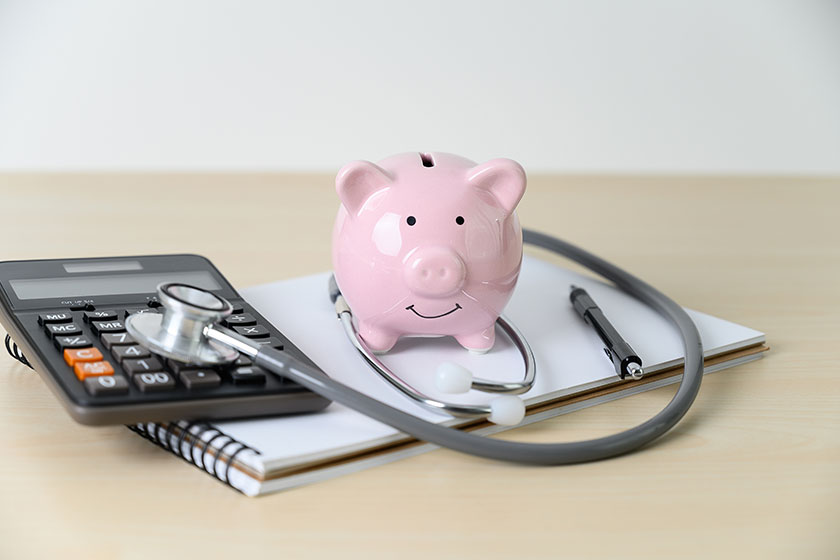 Piggy bank with stethoscope financial checkup or saving for med Piggy bank with stethoscope financial checkup or saving for med