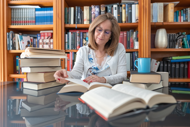 senior white woman reading book glass table senior white woman reading book glass table