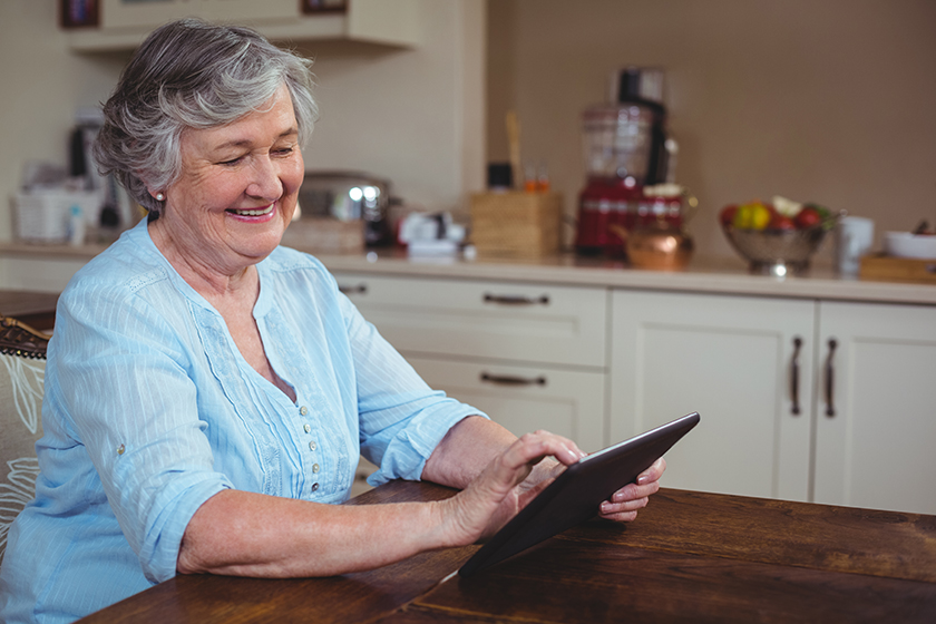 Smiling senior woman using tablet