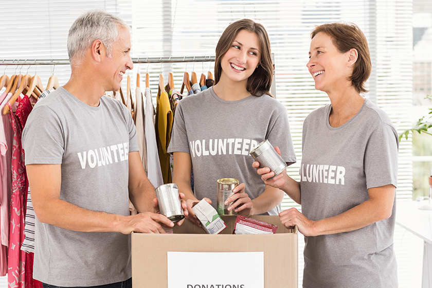 Smiling volunteers sorting donations