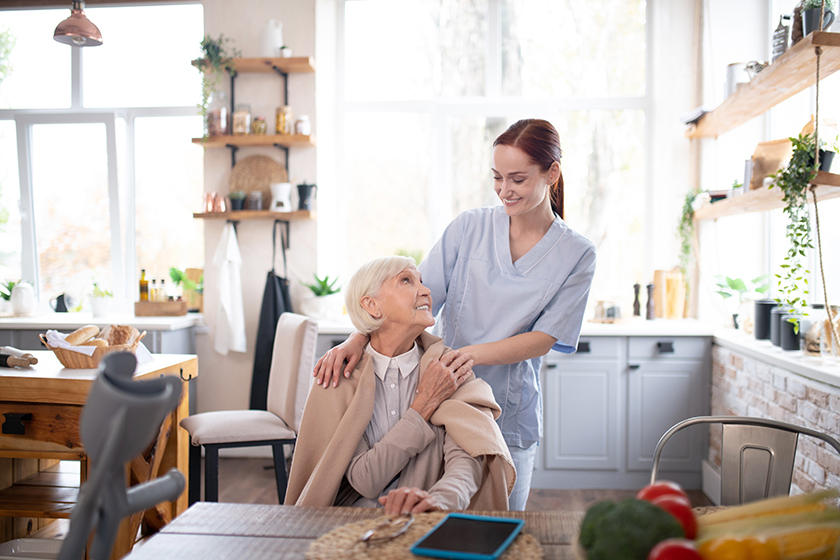Aged pensioner feeling thankful to her pleasant caregiver Aged pensioner feeling thankful to her pleasant caregiver