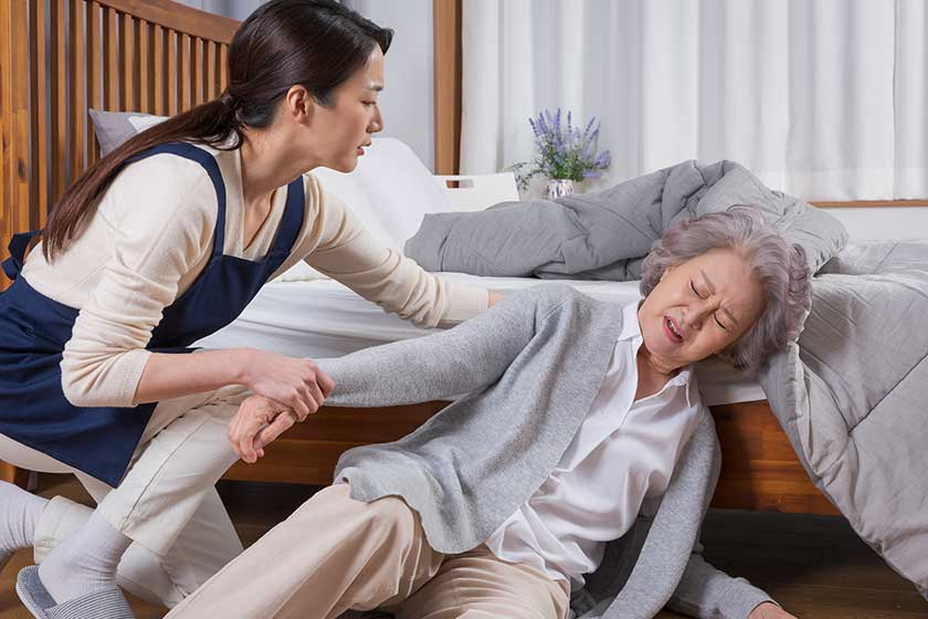 Asian caregiver and old woman at nursing home Asian caregiver and old woman at nursing home