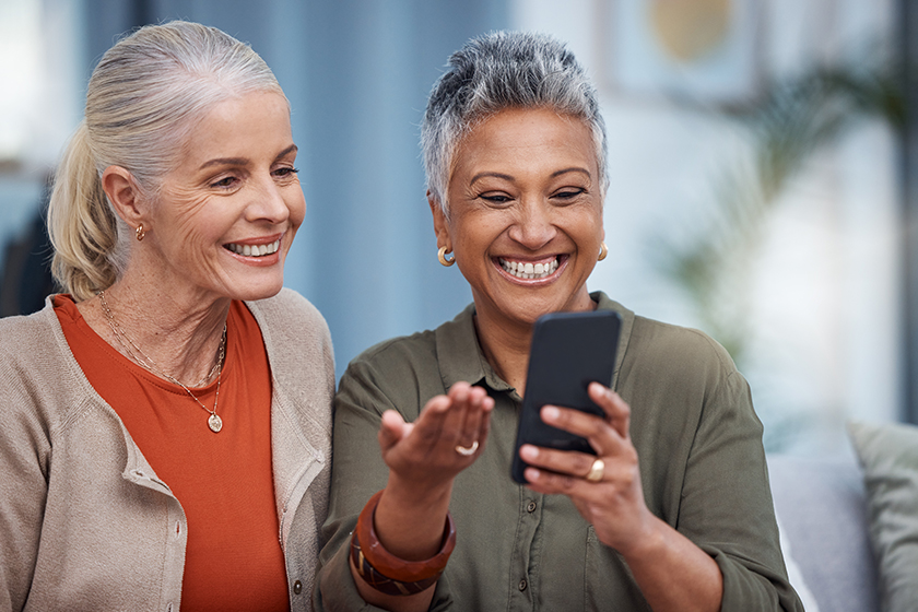 Elderly women smile, phone social media