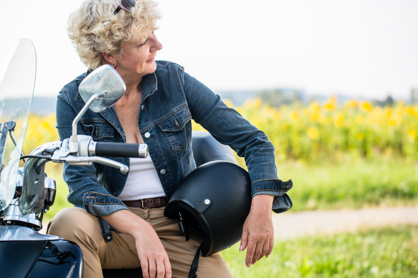 Active senior woman wearing a blue denim jacket while sitting on Enjoying Fun Outdoor Activities as You Age in An Independent Living Home in Rogers, AR