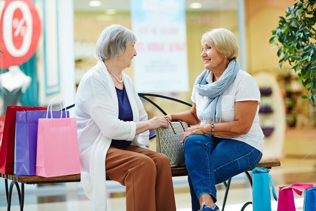 Friendly women relaxing on bench