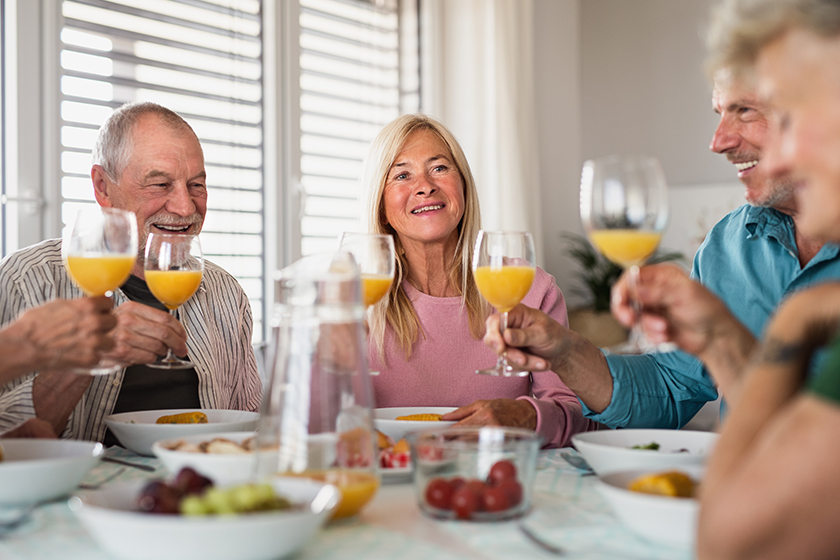 Group of senior friends having party indoors
