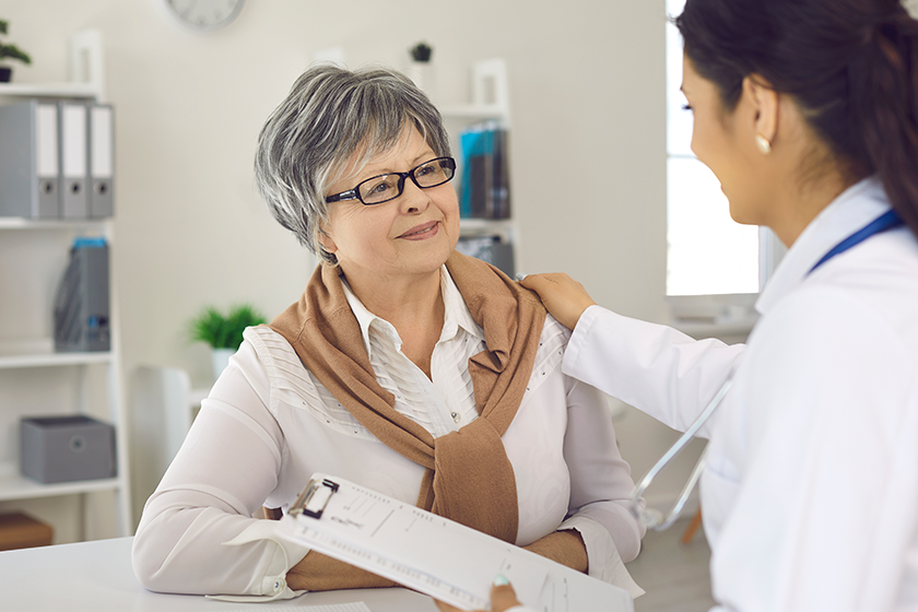 Happy senior woman talking to her nurse
