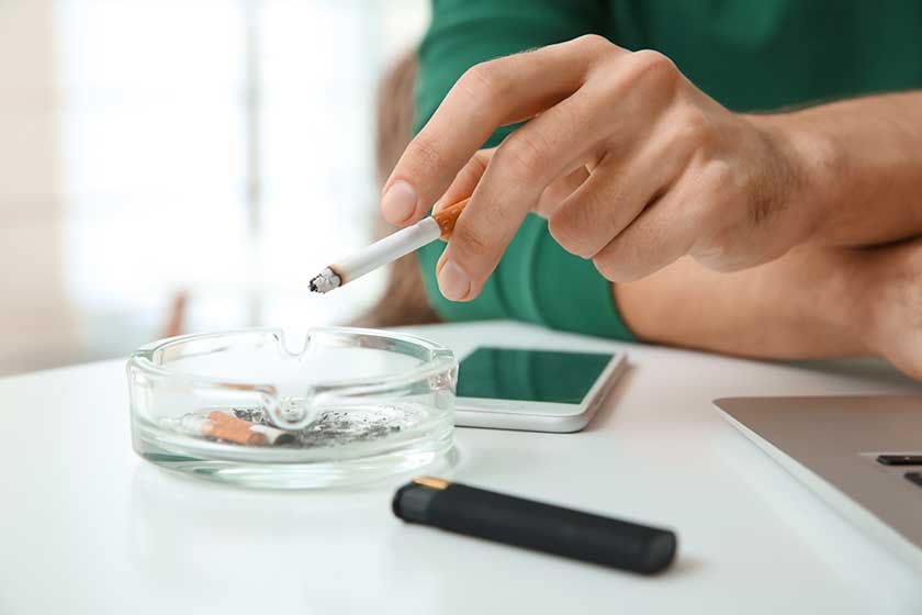 Male hand ashing his cigarette