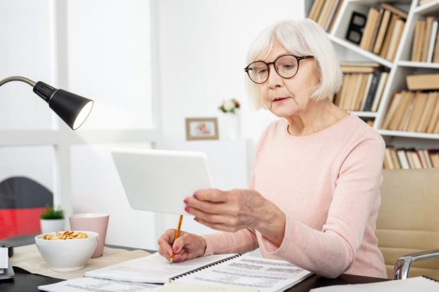 Pleasant senior woman recording lecture