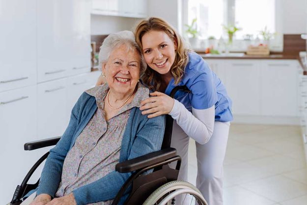 Portrait of nurse and her senior client on a wheelchair