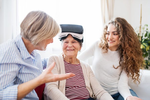 A teenage girl, mother and grandmother with VR goggles at home. Self-Care And Mindfulness When Caring For Parents: Why It Matters