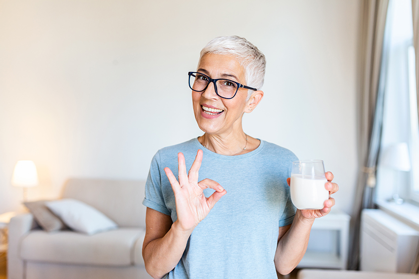 Senior woman's hands holding a glass of milk