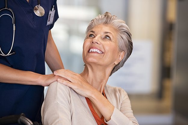 Senior woman on wheelchair talking to nurse Senior woman on wheelchair talking to nurse