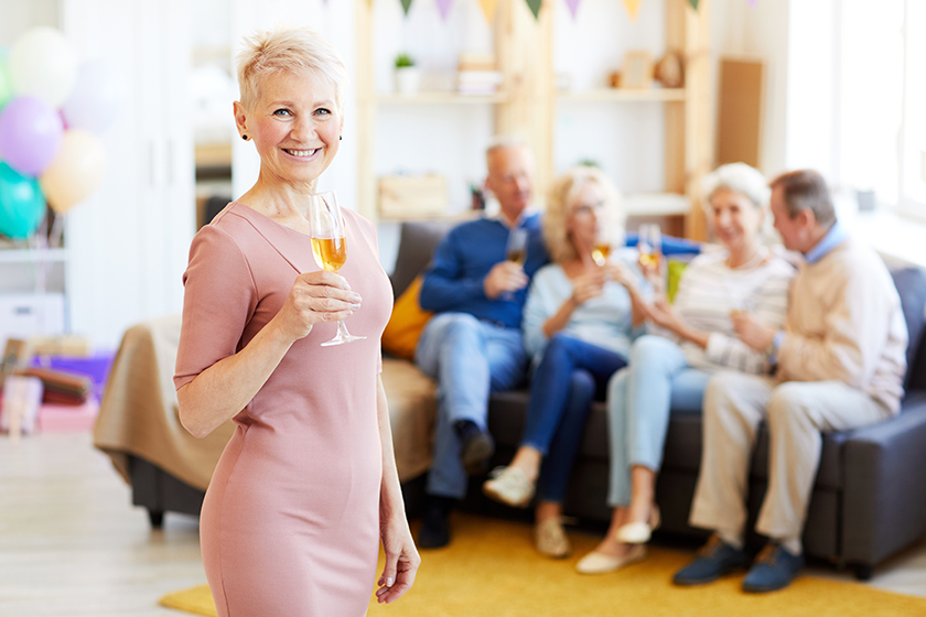 Smiling beautiful mature lady in pink dress