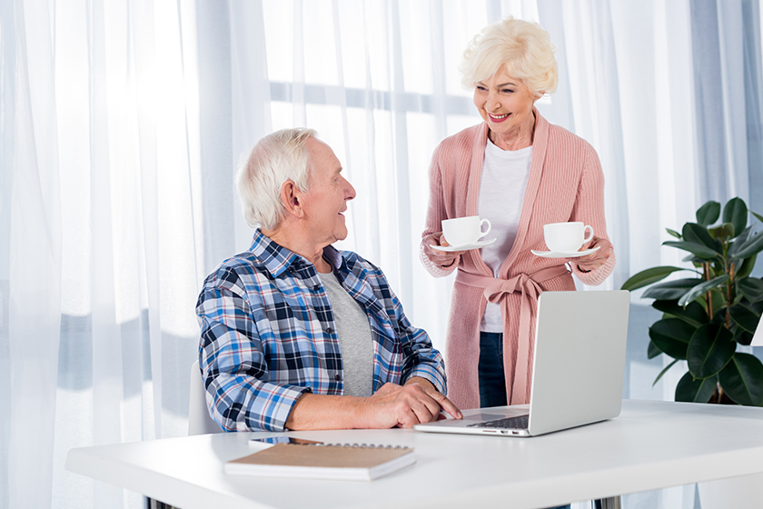Smiling senior man sitting at table Smiling senior man sitting at table