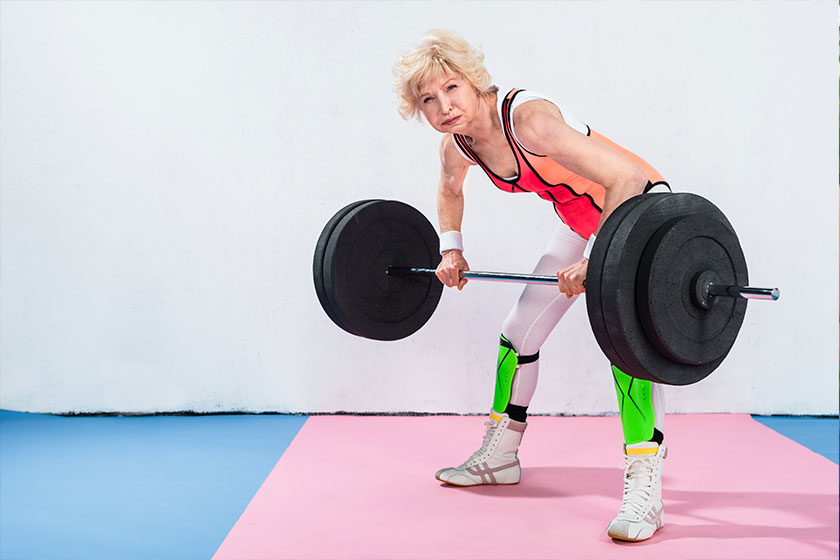 beautiful sportive senior lady lifting barbell