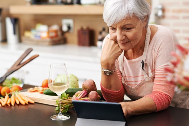 Closeup shot attractive senior woman watching digital tablet