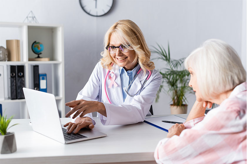 Doctor pointing hand patient looking laptop Doctor pointing hand patient looking laptop