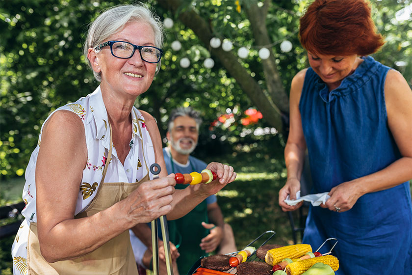 Elderly people making barbeque